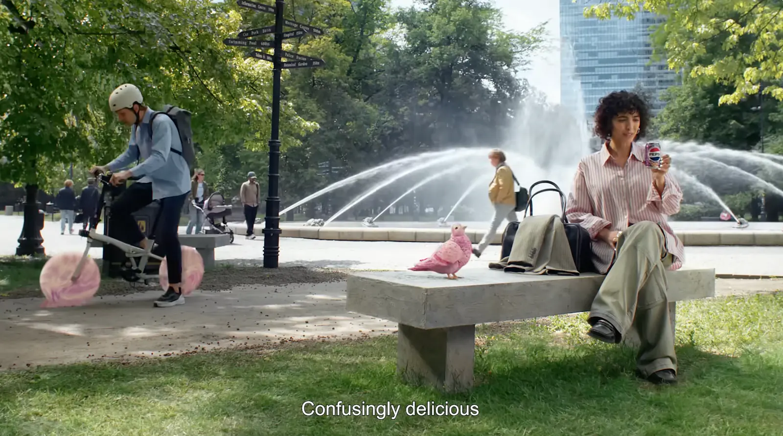 Pidge beside a woman drinking Pepsi in a city park