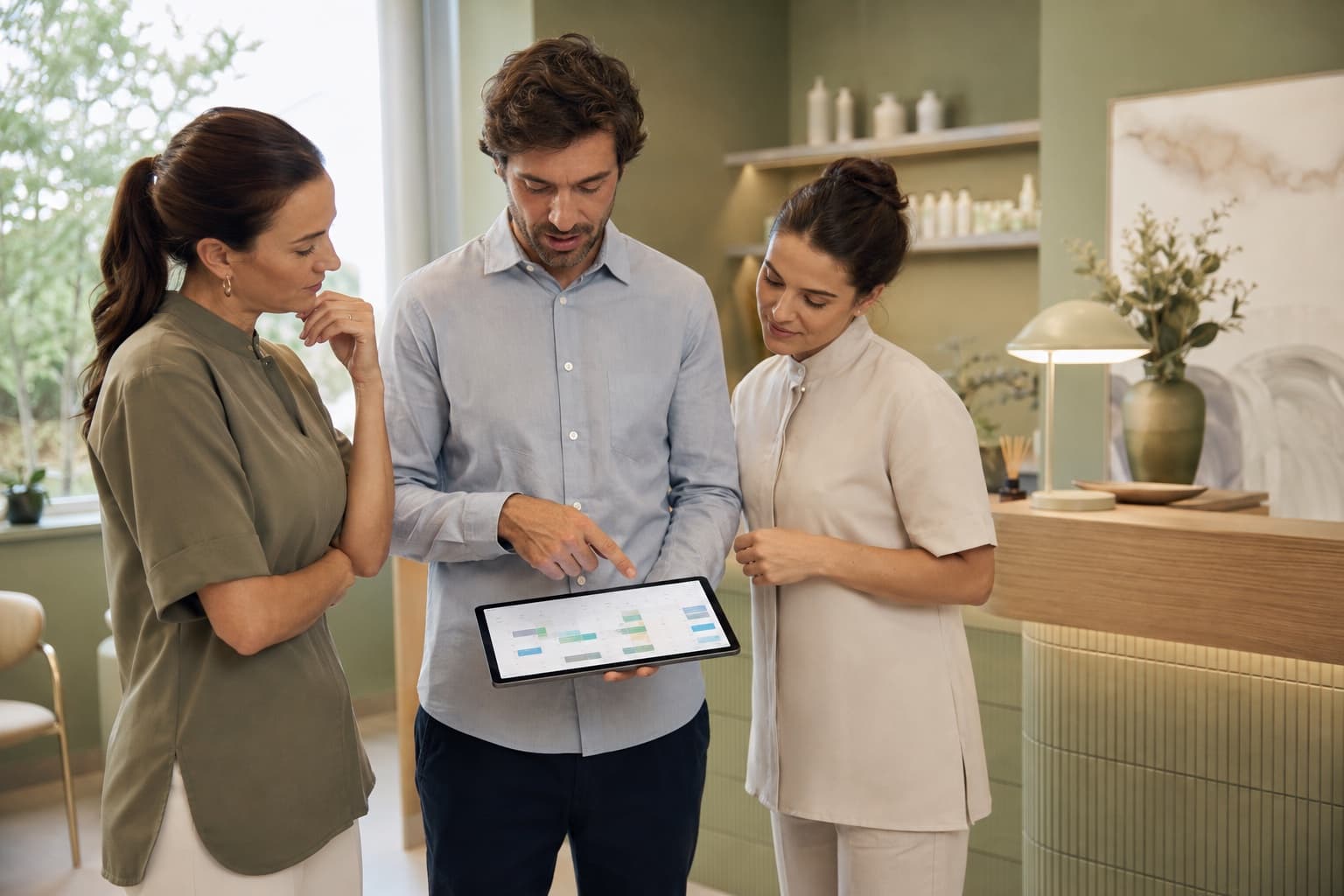 A team reviewing its schedule together on a tablet in a bright studio